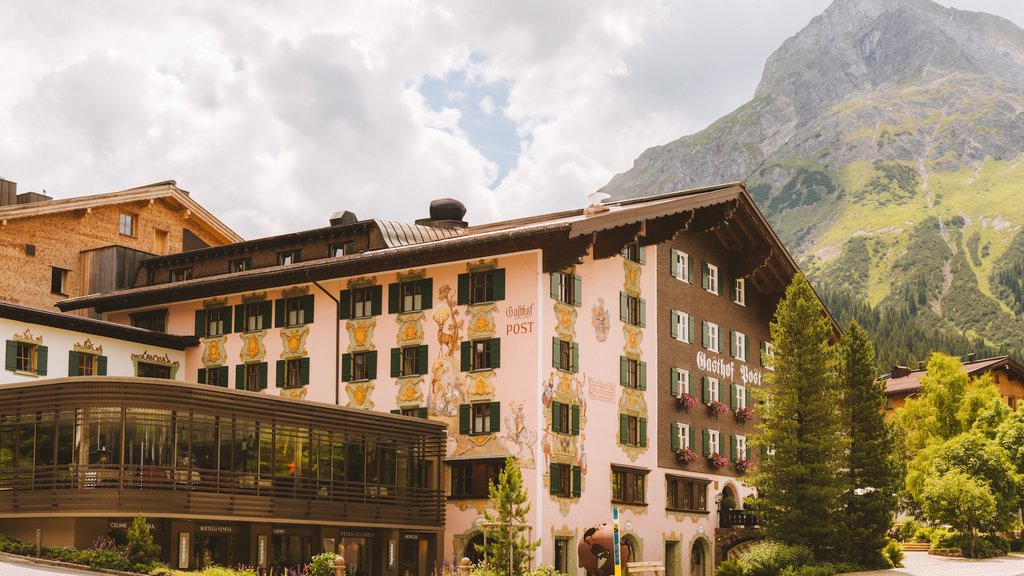 Traditional inn with painted walls and mountains in the background