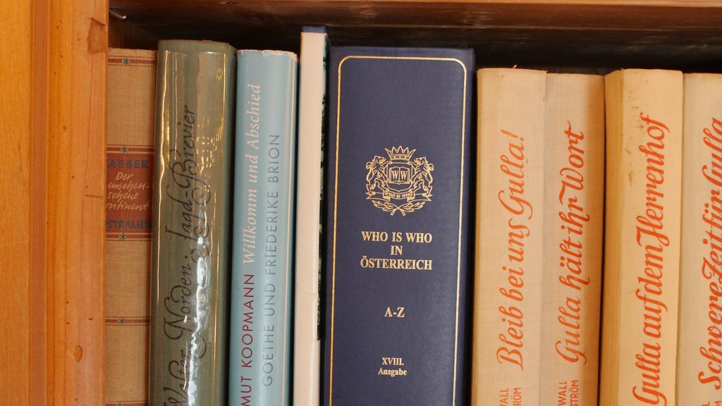Shelf with various German books and binders