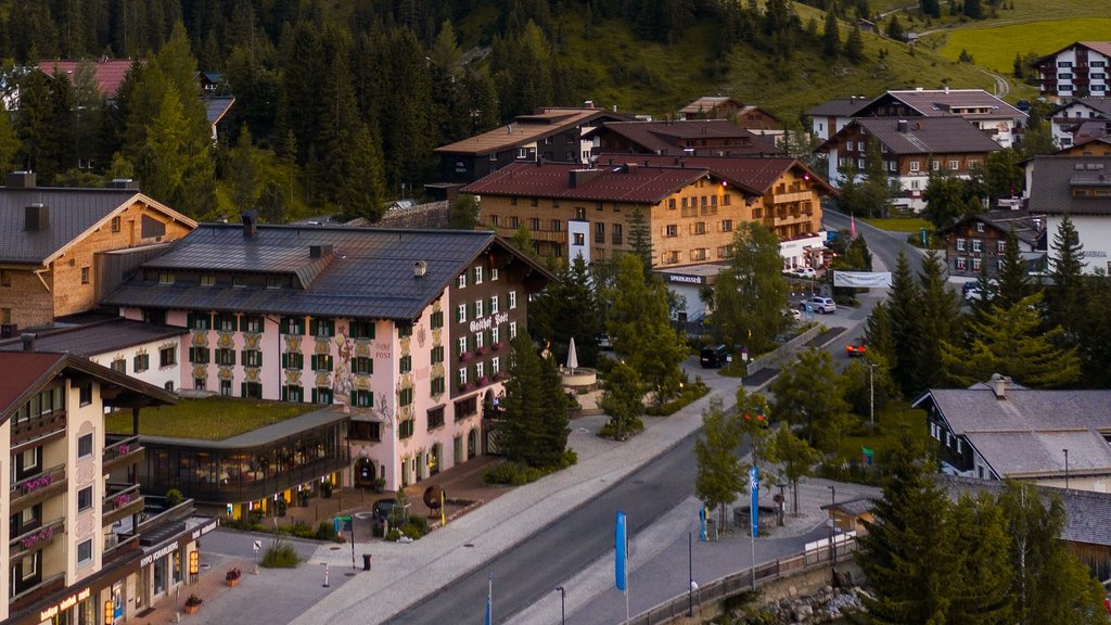 Miles & More Partner Blick auf Dorf mit Bergen und bewaldeten Hängen im Hintergrund bei klarem Himmel