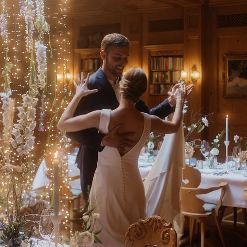 Bride and groom dancing in a decorated room with string lights and flowers
