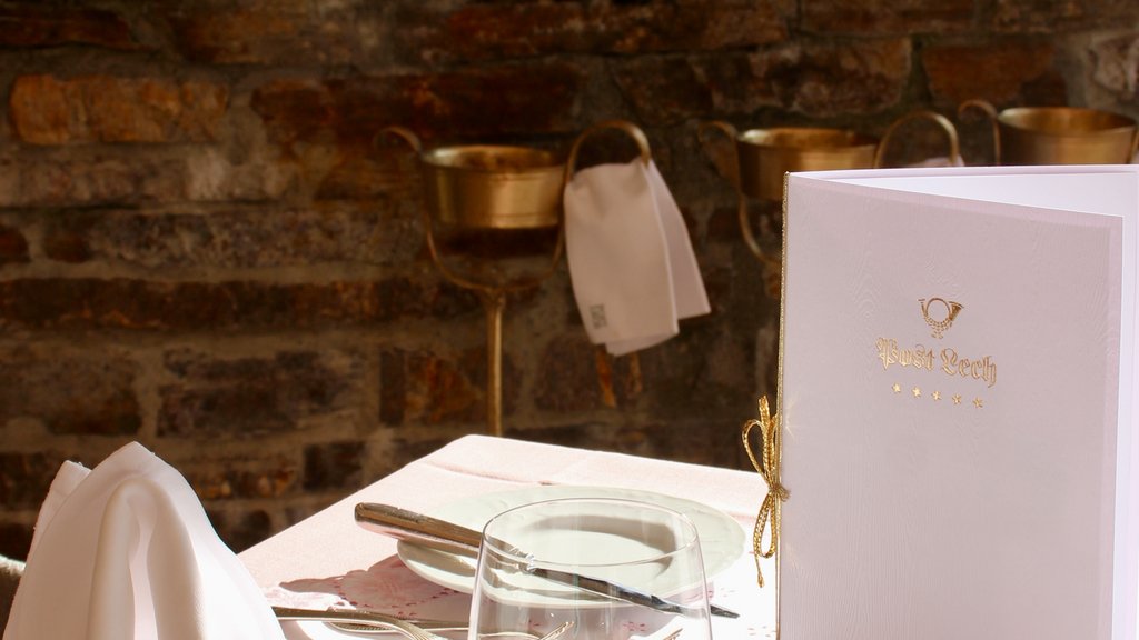 Elegant set table in sunny restaurant with menu and cutlery