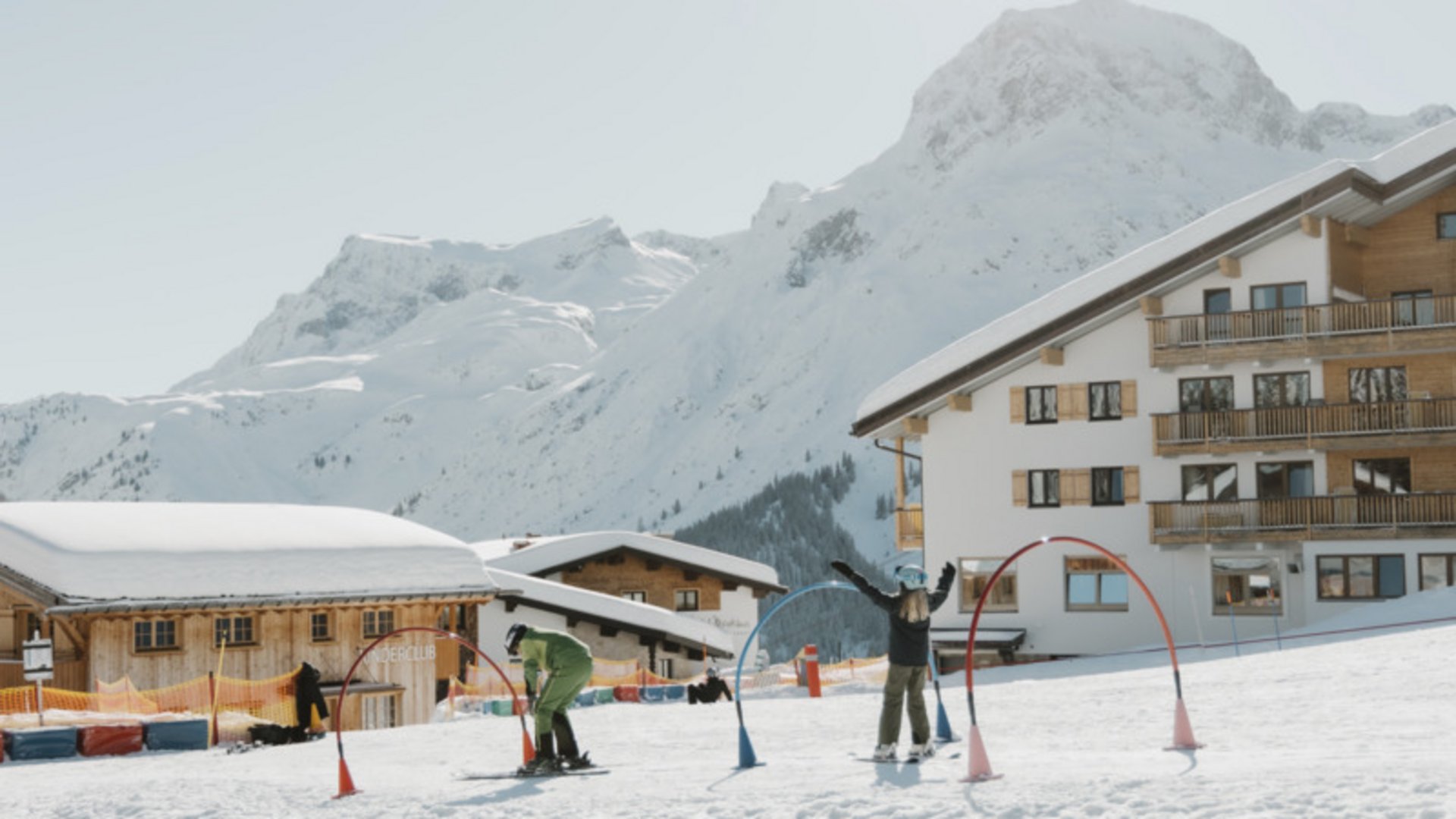 Skier skiing down snowy slope in the Alps under clear sky