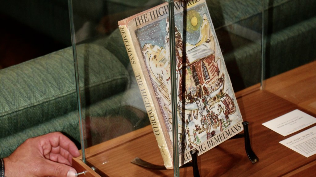 A new chapter in the "Hubertushalle" Illustrated book displayed in a glass case on a wooden table