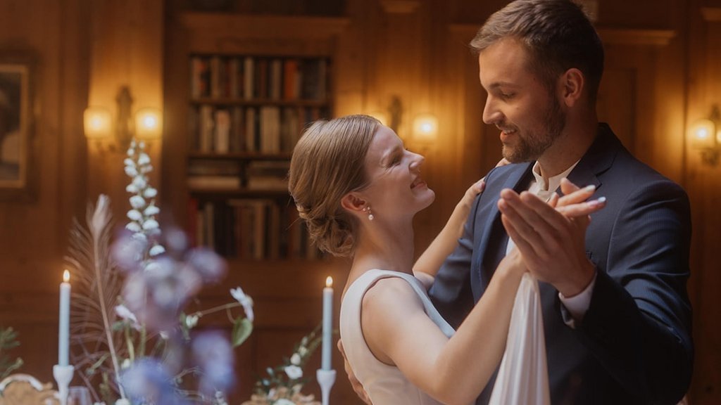 Bride and groom happily dancing at a wedding in a decorated hall