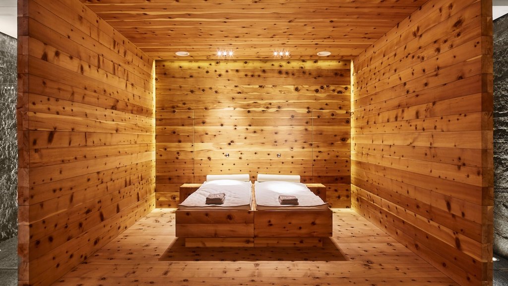 Wooden sauna with two lounge chairs and warm lighting